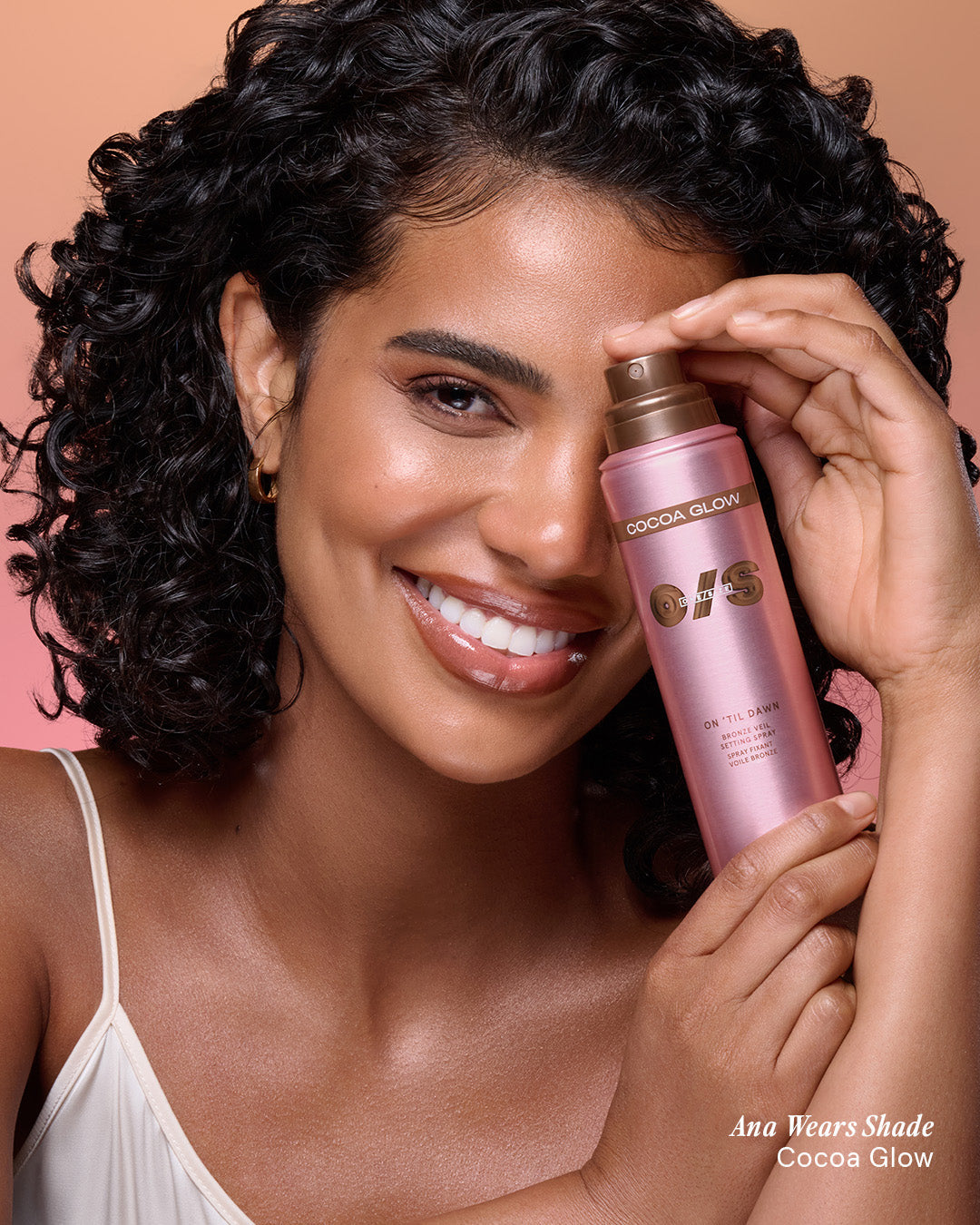 Beauty shot of a model wearing On 'Til Dawn Bronze Veil Setting Spray in Cocoa Glow for a luminous, bronzed finish