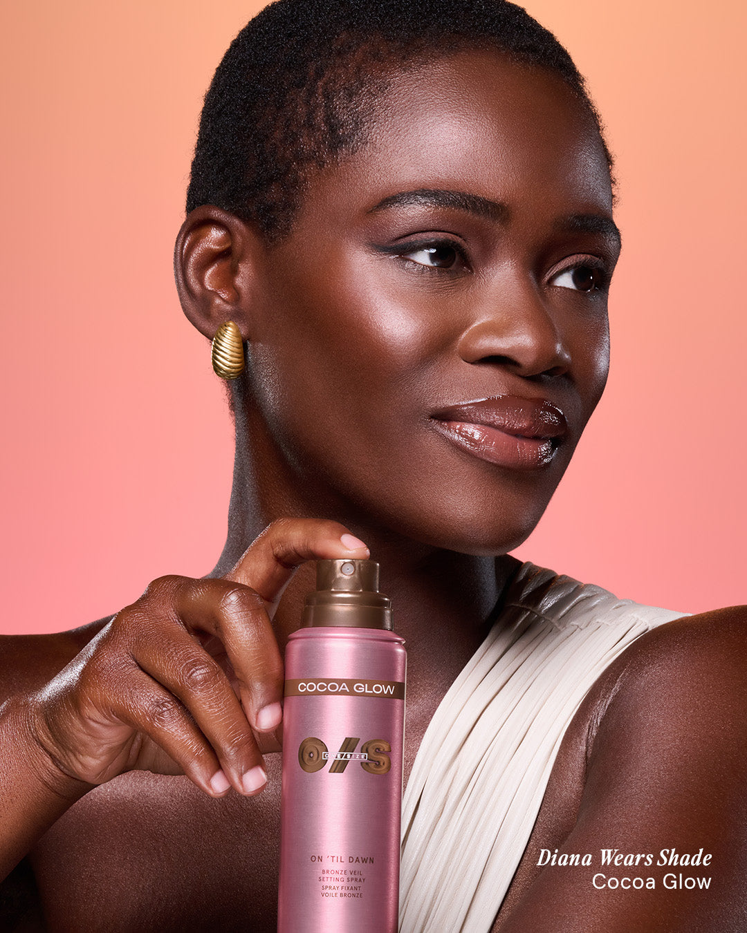 Beauty shot of a model wearing On 'Til Dawn Bronze Veil Setting Spray in Cocoa Glow for an illuminated, sun-kissed finish