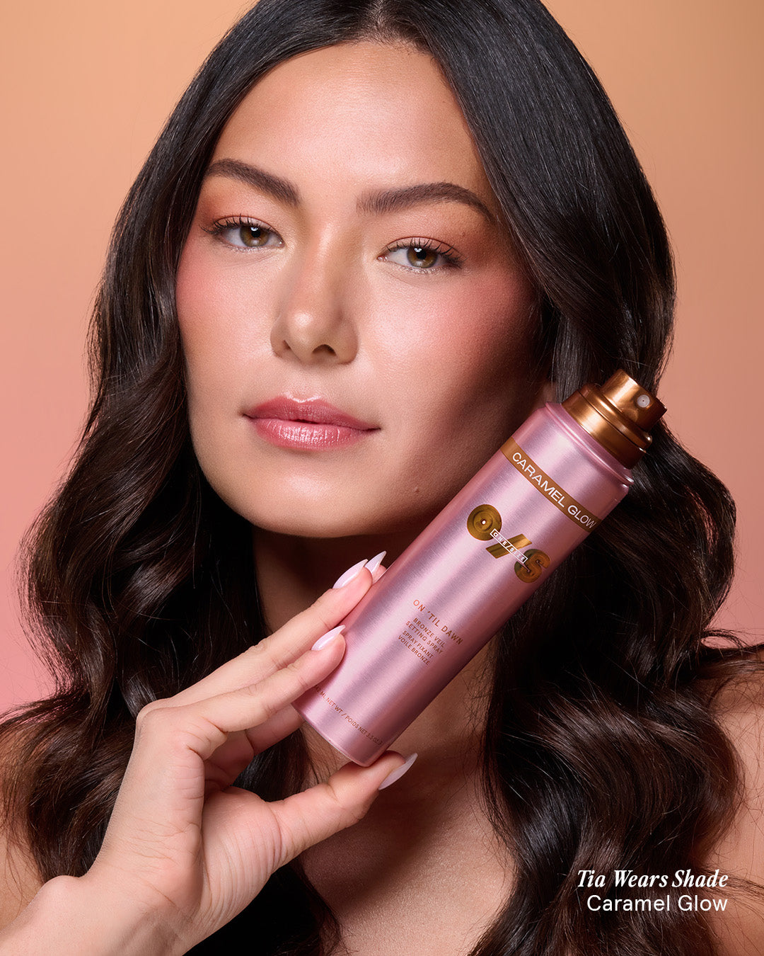 Beauty shot of a model wearing On 'Til Dawn Bronze Veil Setting Spray in Caramel Glow for a luminous, bronzed finish